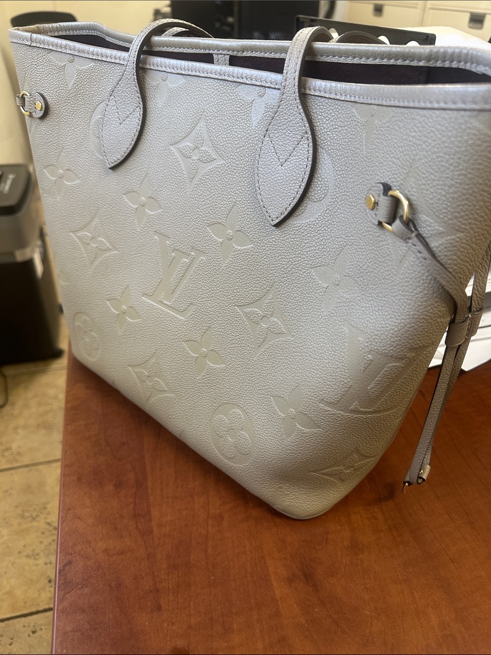 L V Embossed Monogram Leather Tote in Light Gray, MM ,
11.4” x 12.6 “
